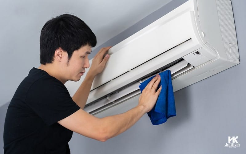 Wiping An Indoor AC Unit With a Cloth