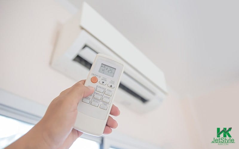 A person holding an aircon remote controller-Aircon Services Singapore