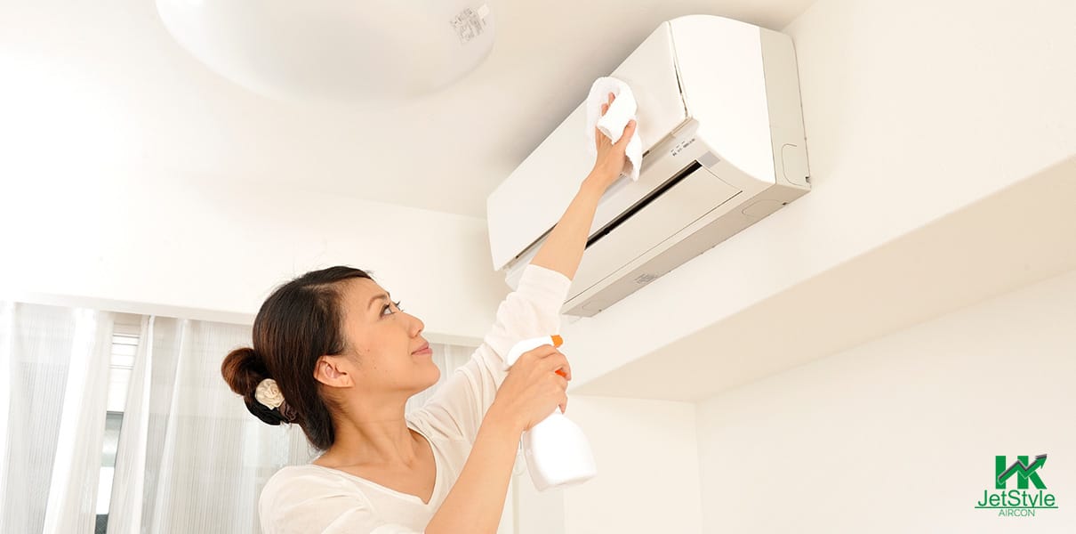 Asian Homeowner Cleaning The Exterior Of The Aircon At Home